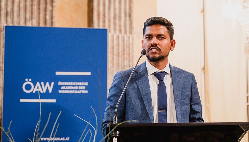 Hari Baskar Balasubramanian with a microphone making a speech